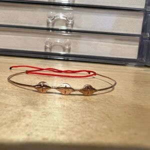 Elegant Gold Bracelet with Red Cord